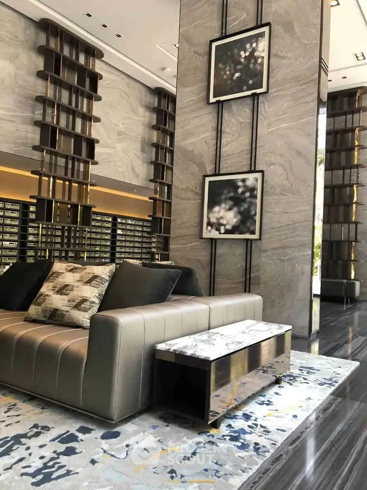 Luxurious modern lobby with elegant decor and plush seating in a high-end building.
