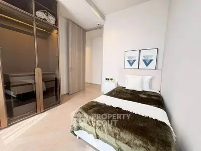 Modern bedroom with sleek wardrobe and cozy bed in stylish apartment