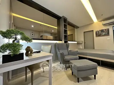 Modern studio apartment with stylish decor and cozy seating area