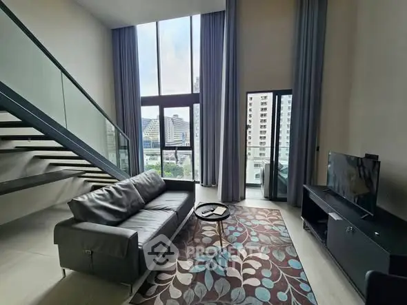 Modern loft living room with high ceilings and city view
