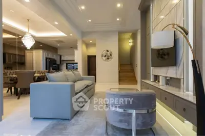 Luxurious open-plan living room with elegant decor and modern lighting