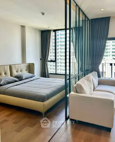 Modern bedroom with glass partition and city view, featuring elegant decor and cozy ambiance.