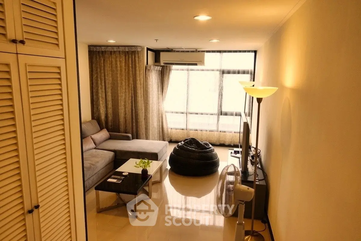 Spacious living room with modern decor and large windows for natural light.