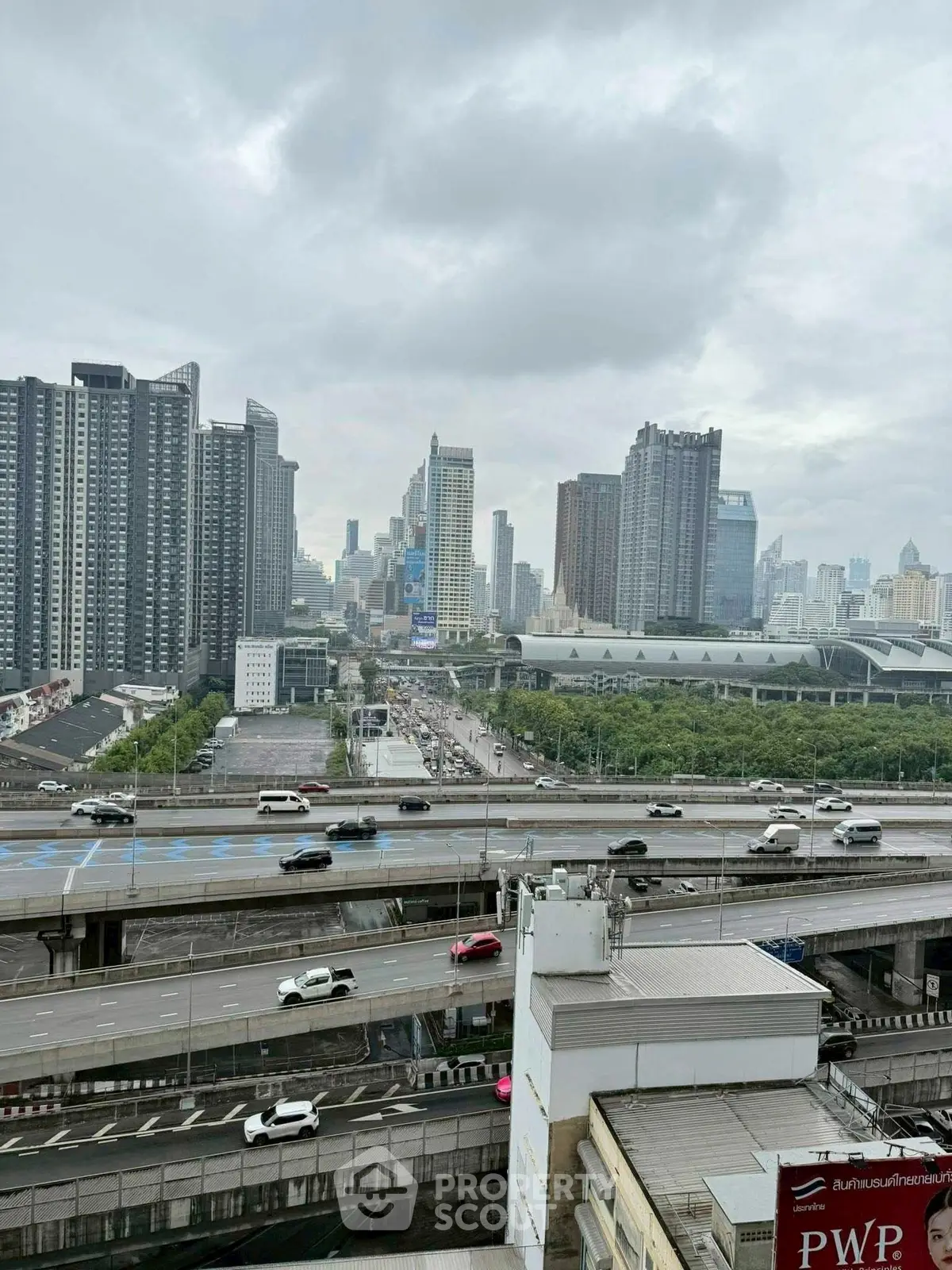 Stunning cityscape view with modern skyscrapers and bustling highways, perfect for urban living.