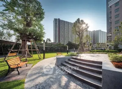 Luxurious residential complex with lush garden and modern architecture