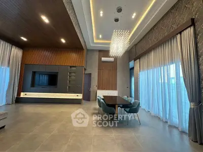 Luxurious modern dining room with high ceilings and elegant chandelier