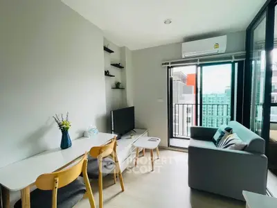 Modern living room with balcony view, stylish furniture, and natural light in a contemporary apartment.