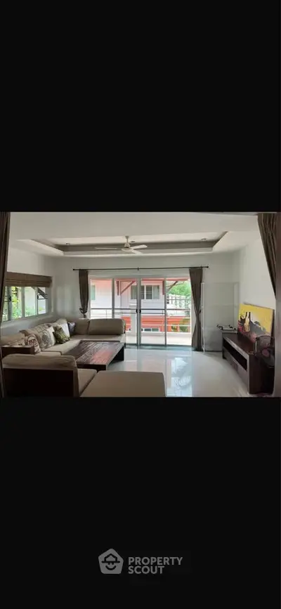 Spacious living room with large windows and modern decor