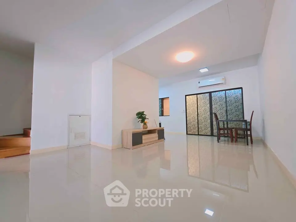 Spacious modern living room with dining area and sleek flooring