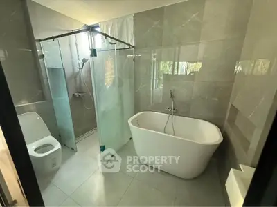 Modern bathroom with freestanding bathtub and glass shower enclosure