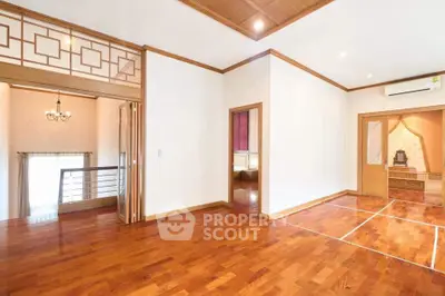 Spacious living room with wooden flooring and elegant design in a modern home.