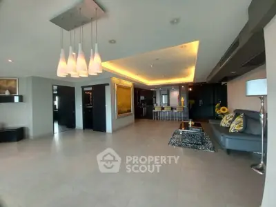 Spacious modern living room with open kitchen and stylish lighting