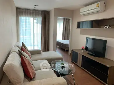Modern living room with cozy sofa, TV, and air conditioning in a stylish apartment.