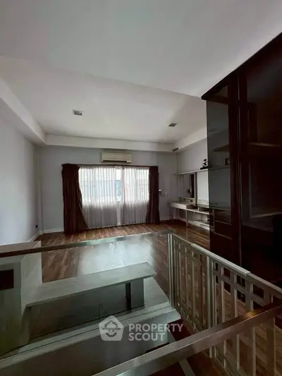 Spacious living room with modern design and large window for natural light.