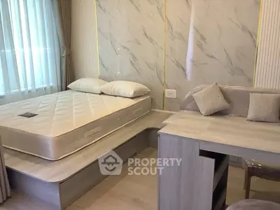 Modern bedroom with stylish decor and built-in furniture, featuring a comfortable bed and elegant desk.