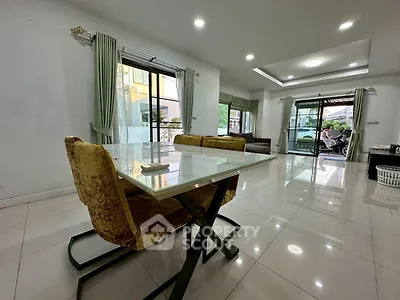 Spacious modern living room with elegant dining area and large windows