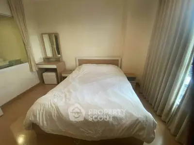 Cozy bedroom with a comfortable bed and elegant curtains, perfect for relaxation.
