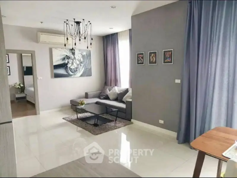 Modern living room with elegant decor and natural light in a stylish apartment.