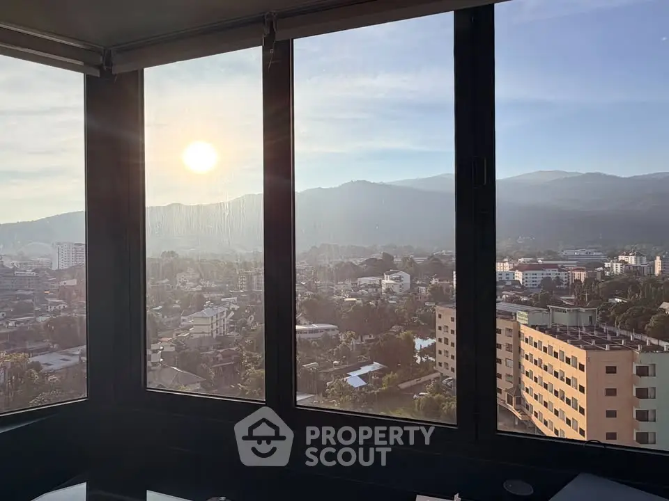 Stunning cityscape view from a high-rise window at sunrise, showcasing urban living.