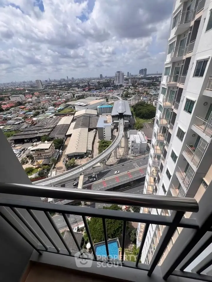 Stunning high-rise balcony view overlooking cityscape and skyline, perfect for urban living enthusiasts.