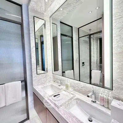Luxurious modern bathroom with dual sinks and elegant marble finishes.