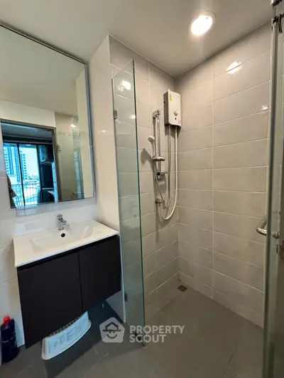 Modern bathroom with sleek shower and vanity in urban apartment