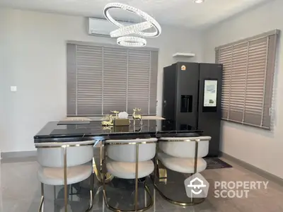 Luxurious modern kitchen with sleek black marble dining table and elegant lighting