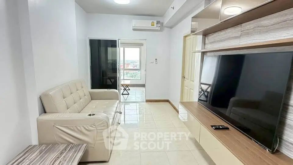 Modern living room with sleek TV unit and comfortable sofa in a bright apartment.