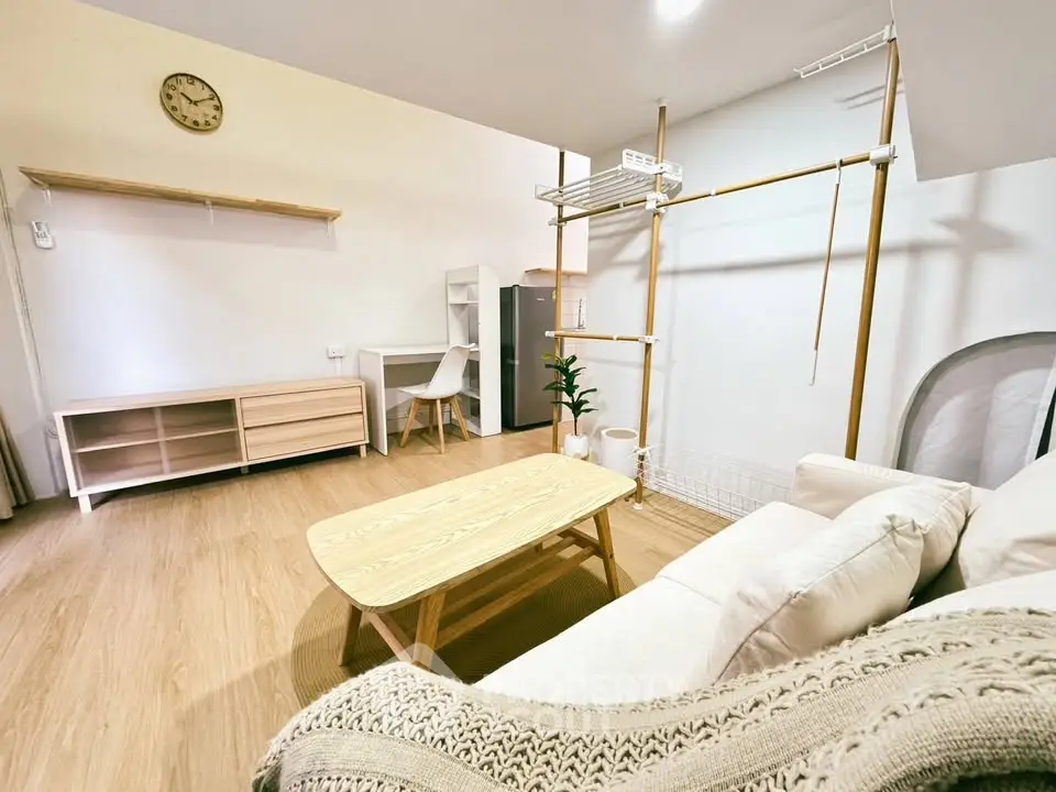 Modern living room with cozy sofa, wooden furniture, and minimalist decor