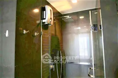 Modern bathroom with glass shower enclosure and sleek fixtures