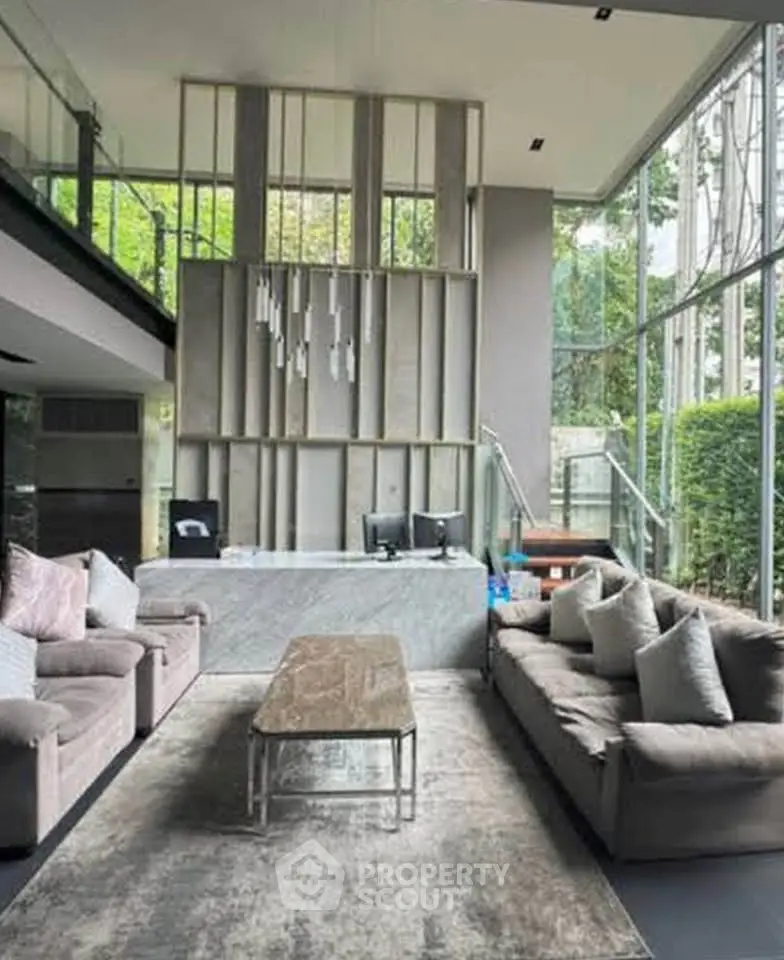 Luxurious modern living room with high ceilings and elegant decor in a stylish property.