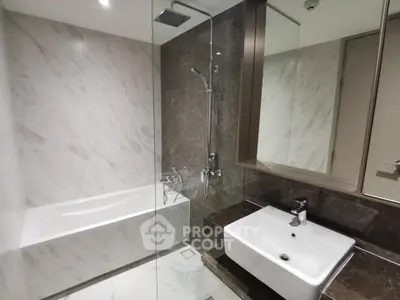 Modern bathroom with sleek marble tiles and contemporary fixtures