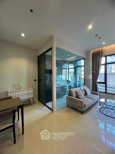 Modern living room with glass partition and stylish furniture in a bright apartment