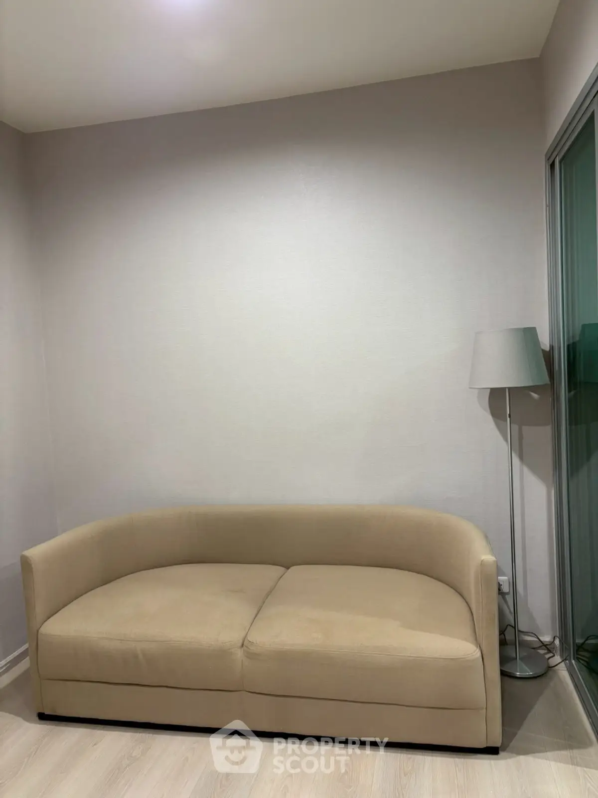 Cozy minimalist living room with beige sofa and modern floor lamp