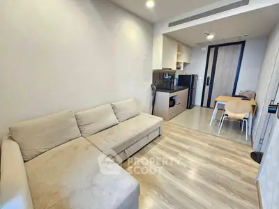 Modern living room with cozy sofa and open kitchen layout in stylish apartment