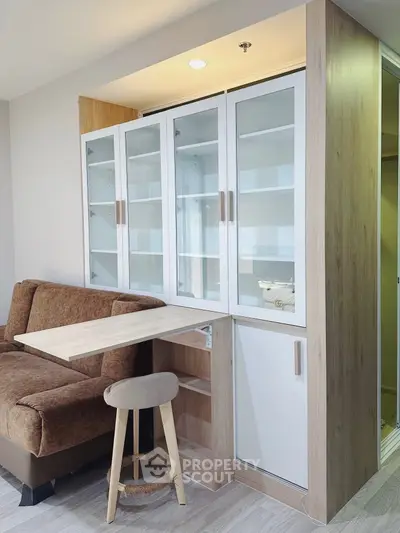 Modern living room with stylish furniture and built-in storage solutions.