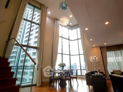 Luxurious high-rise living room with floor-to-ceiling windows and stunning city views.
