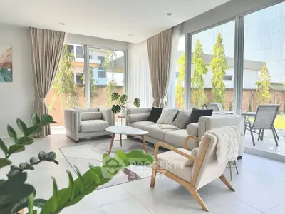 Spacious and bright living room with modern furniture and large windows overlooking a garden.