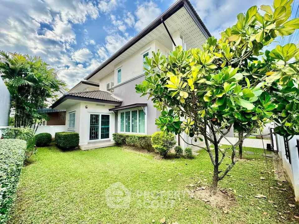 Charming two-story house with lush garden and modern exterior design