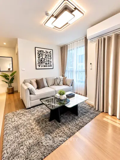 Modern living room with stylish decor, cozy sofa, and elegant lighting in a contemporary apartment.