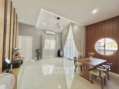 Spacious modern living room with elegant dining area and large windows.
