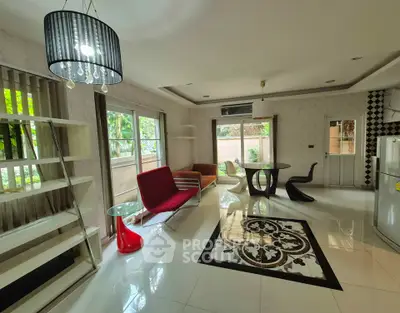 Stylish modern living room with chic furniture and large windows for natural light.
