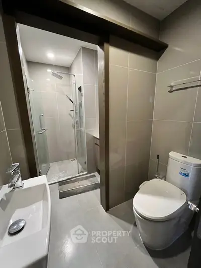 Modern bathroom with sleek fixtures and glass shower enclosure