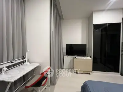 Modern bedroom with sleek furniture and TV setup, ideal for comfortable living.