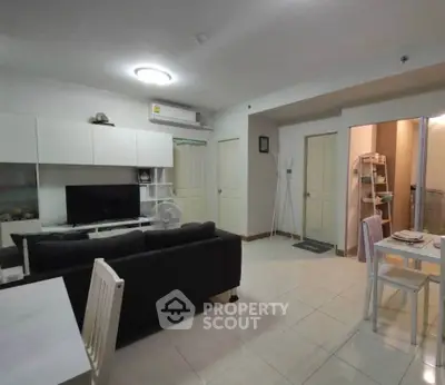 Spacious living room with modern furniture and open layout in a cozy apartment.