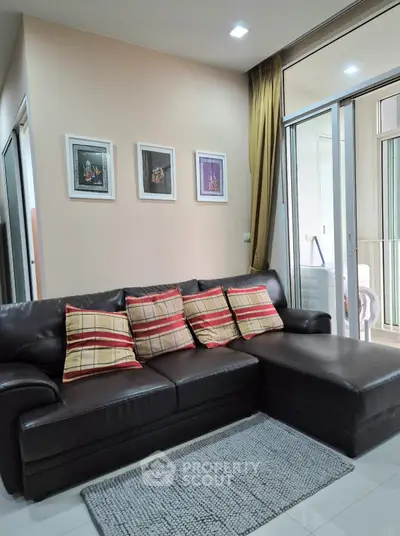 Modern living room with leather sofa and balcony access