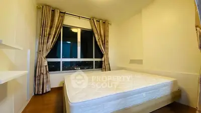 Cozy bedroom with large window and elegant curtains, offering a serene nighttime view.