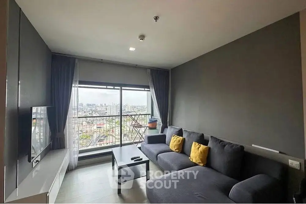 Modern living room with city view, stylish gray sofa and large window.