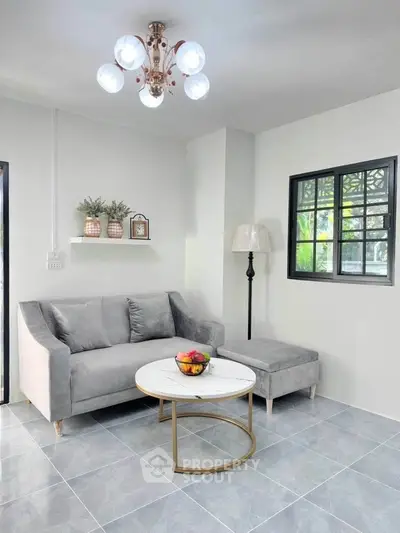 Chic modern living room with stylish gray sofa and elegant lighting