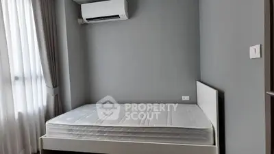 Modern minimalist bedroom with air conditioning and natural light